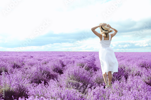 Fototapeta Naklejka Na Ścianę i Meble -  Young woman in lavender field on summer day