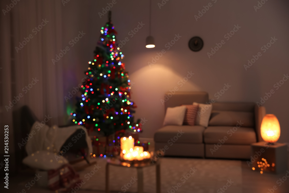 Blurred view of stylish room interior with decorated Christmas tree Blurred view of stylish room interior with decorated Christmas tree