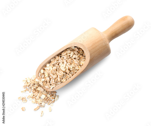 Scoop with raw oatmeal on white background. Healthy grains and cereals