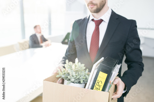 Bilde på lerret Mid section portrait of handsome businessman holding box of personal belongings