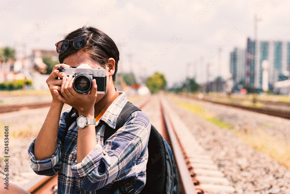 young hipster Asian woman wearing plaid shirt holding the camera vintage young hipster Asian woman wearing plaid shirt holding the camera vintage