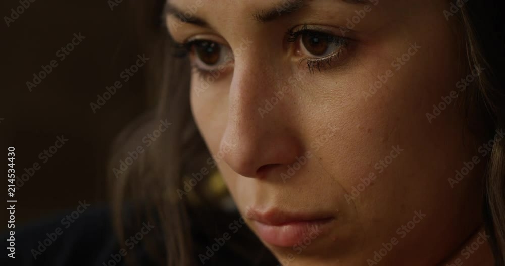 Woman watching show on laptop - slow zoom in to face Woman watching show on laptop - slow zoom in to face