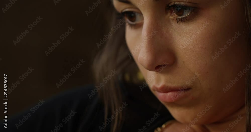 Woman watching show on laptop - tilt up to reveal tired face Woman watching show on laptop - tilt up to reveal tired face