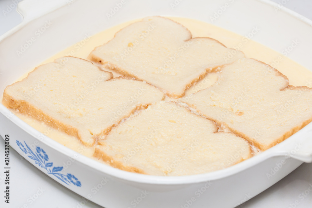 French toast preparation: Soaking bread in the mix for french toast preparation French toast preparation: Soaking bread in the mix for french toast preparation
