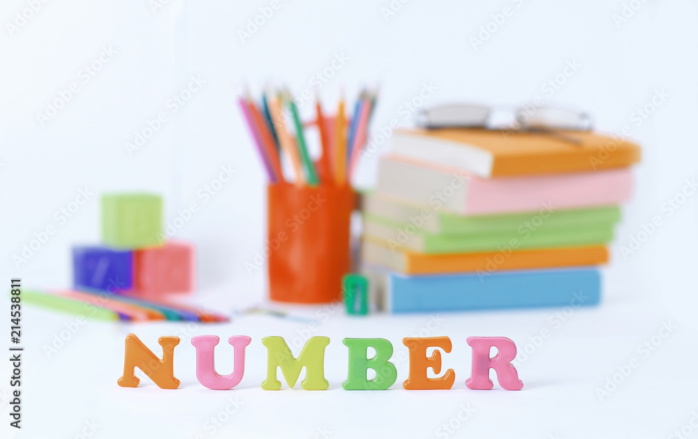 word number on blurred background of school supplies .photo with copy space word number on blurred background of school supplies .photo with copy space