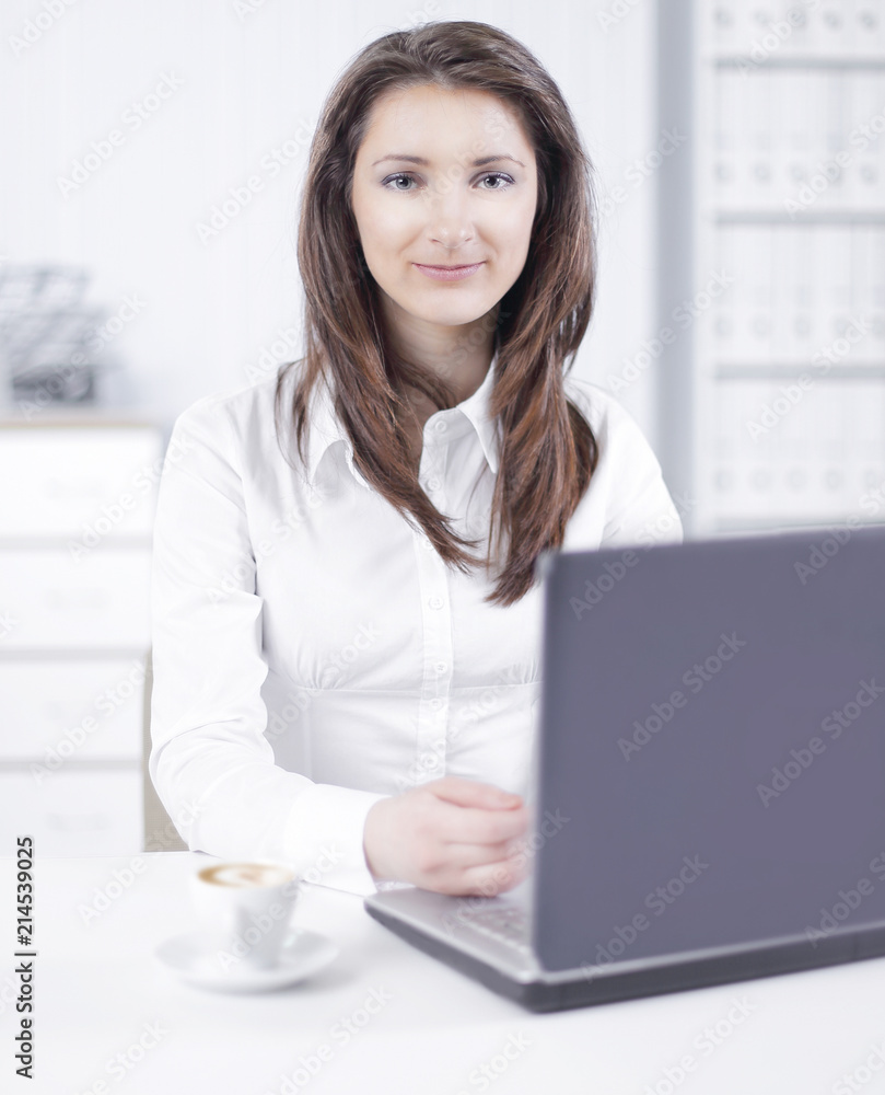 friendly female employee sitting at her Desk. friendly female employee sitting at her Desk.