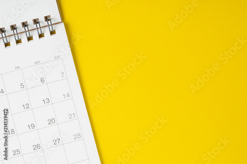 White clean calendar on solid yellow background with copy space, business, travel or project planning concept photo