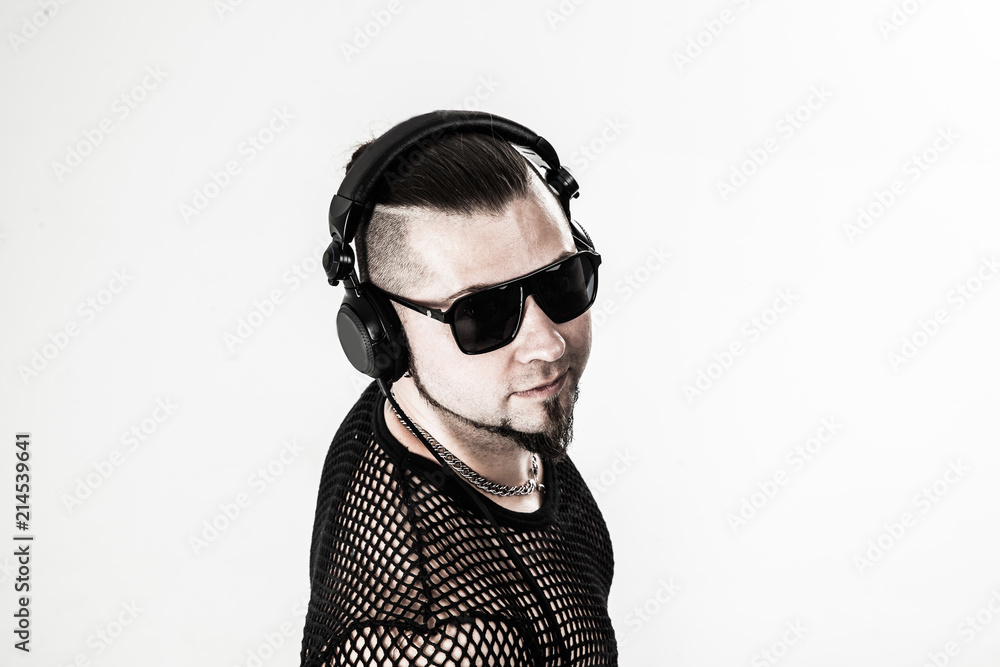 emotional and charismatic DJ - rapper with headphones on a light