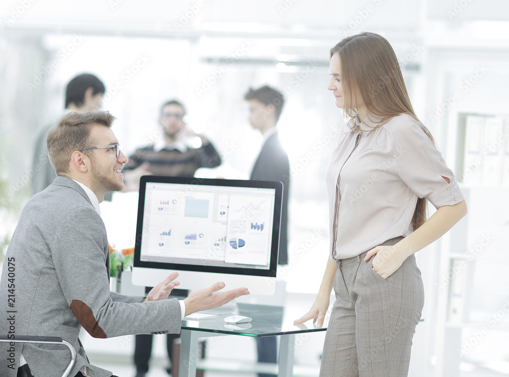 two employees of the company discussing financial data two employees of the company discussing financial data