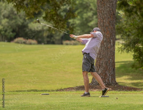 unknown golfer follows through with his swing
