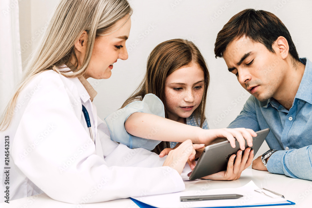 Doctor consulting and check up information with little girl in hospital.A little girl has sick.healthcare and medicine Doctor consulting and check up information with little girl in hospital.A little girl has sick.healthcare and medicine