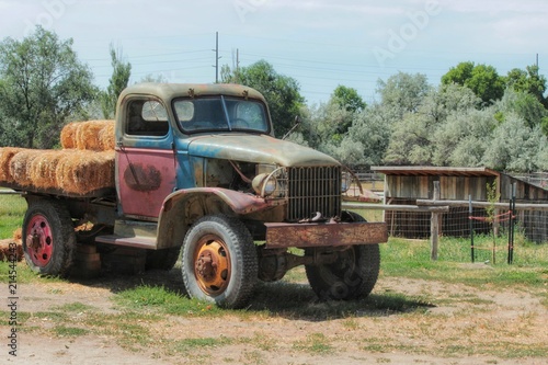 Rusted and old farm vehicle carrying hay bales