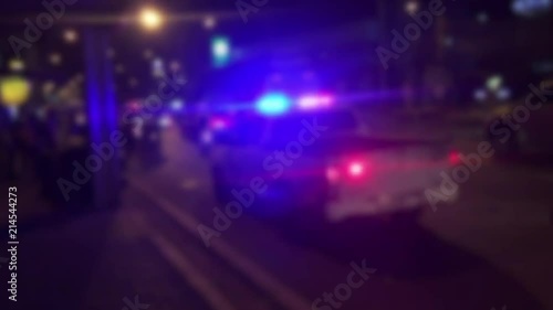 lighting of police car in the night during accident on the road when raining.