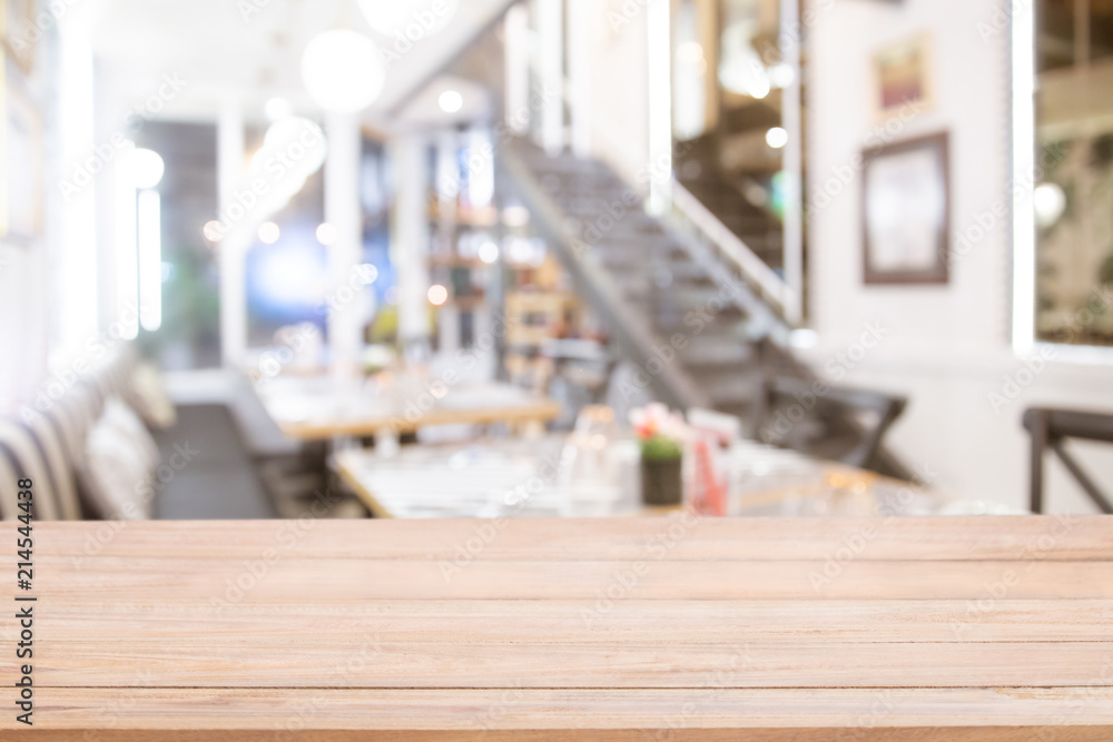 Empty wooden bar counter with Abstract blur beautiful luxury restaurant or  coffee shop.