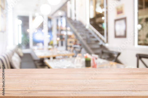 Empty wooden bar counter with Abstract blur beautiful luxury restaurant or  coffee shop.