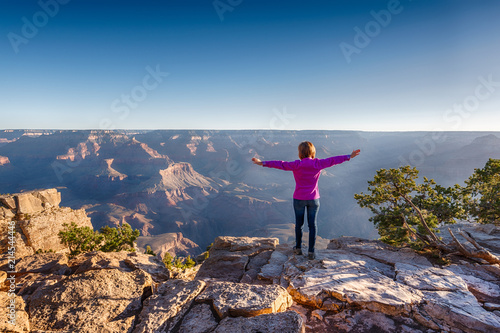 Girl in Purple Hoodie is Standing on the Edge of Grand Canyon
