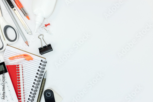 фотографія notebooks, calculator, glue and other office supplies on white table background
