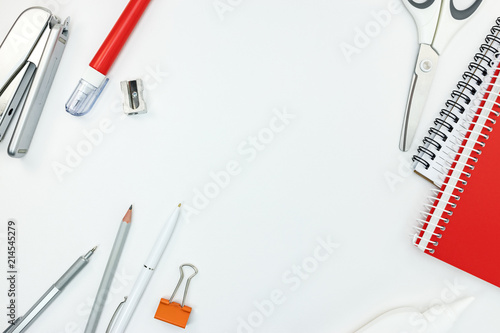 different stationary on table. office tools on white background. top view