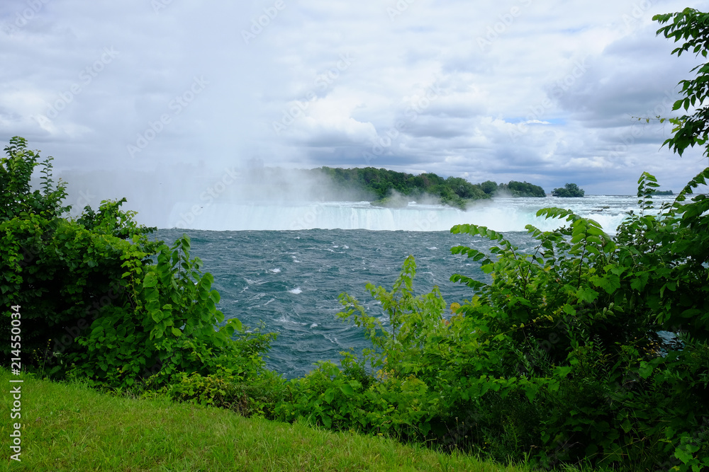 Mist and spray rising over the water falling into Niagara Falls Mist and spray rising over the water falling into Niagara Falls