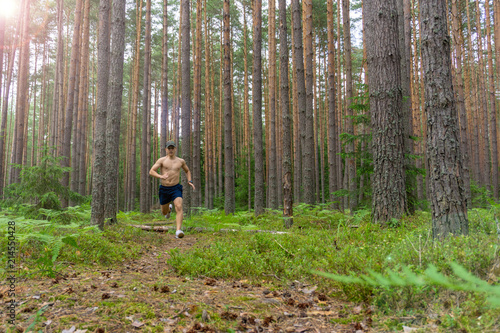 A young man is running along a flattering path photo