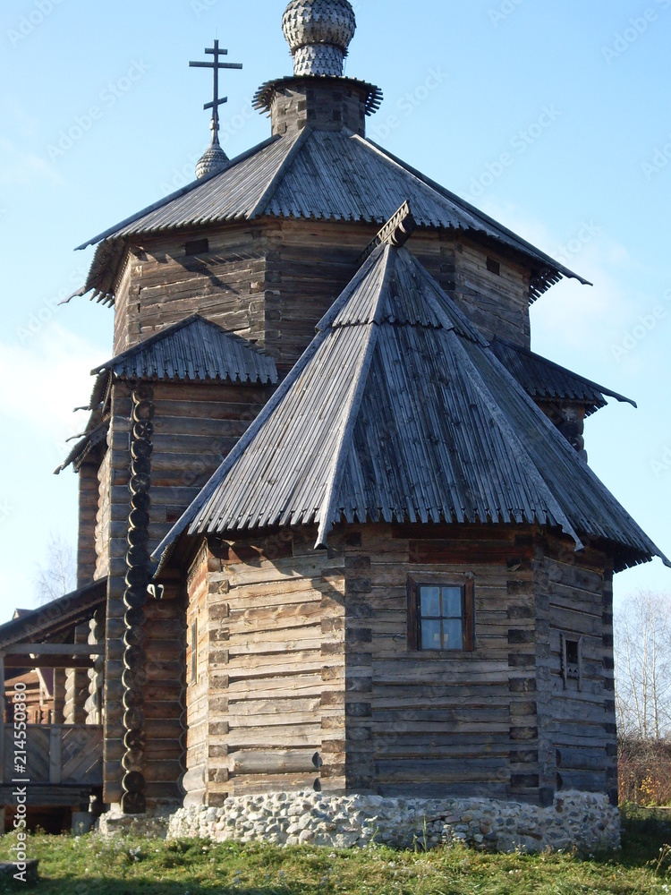 wooden unpainted single-domed church against the blue sky