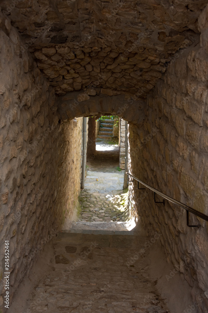 Narrow walkway with cobblestone staircase in the French medieval village Labeaume an der Ardeche