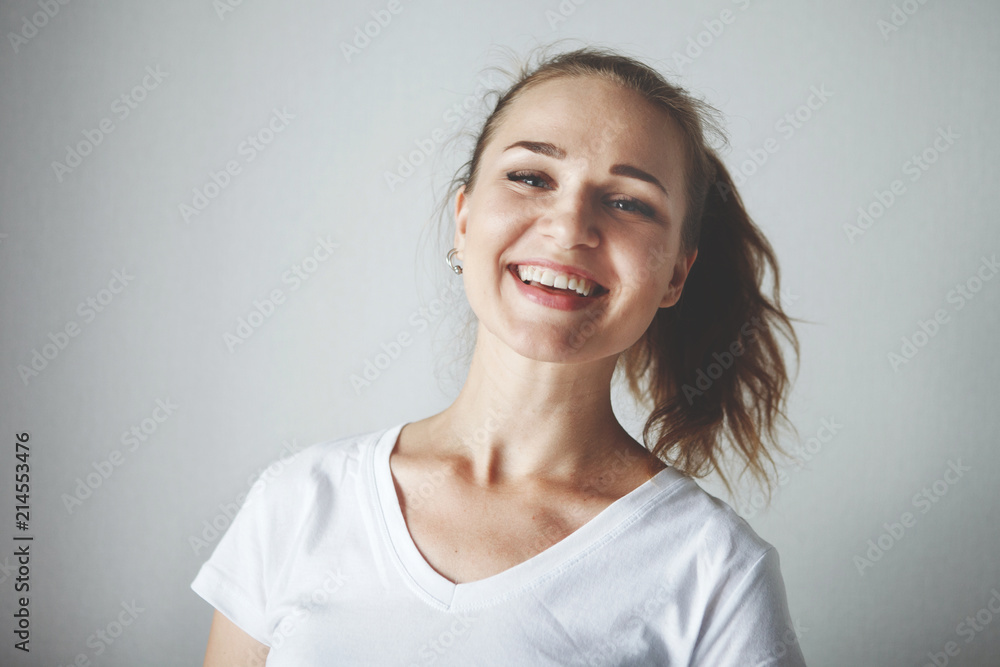 Cute young fairy-eyed girl smiling, looking at camera, on white background close-up. Cute young fairy-eyed girl smiling, looking at camera, on white background close-up.