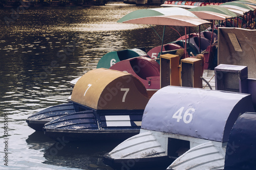 Colorful pedal boats on the lake in the park.
