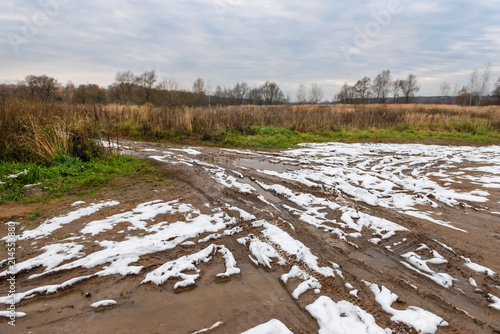 Dirty country trail through an agricultural field in late fall