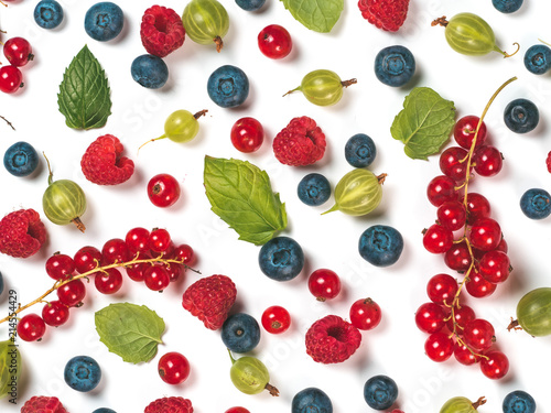 Various fresh summer berries background. Pattern of fresh blueberries, red currant, raspberries, gooseberries isolated on white background. Top view or flat-lay.