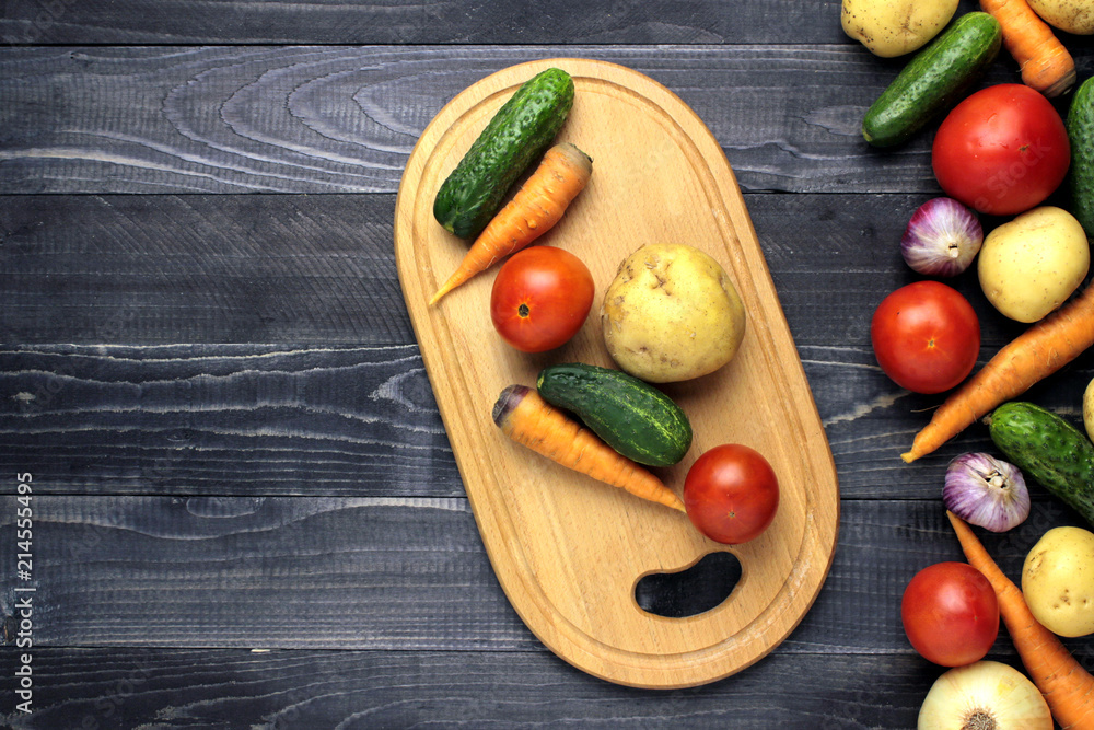 fresh vegetables on black wooden board fresh vegetables on black wooden board