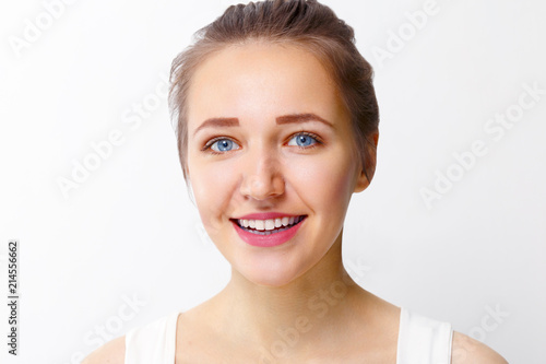 Pretty young girl with make-up smiles in studio  close up portrait