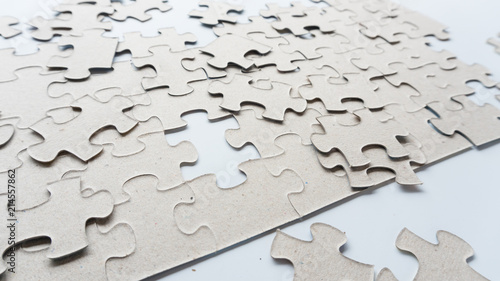 Hand put missing jigsaw puzzle into the paper board