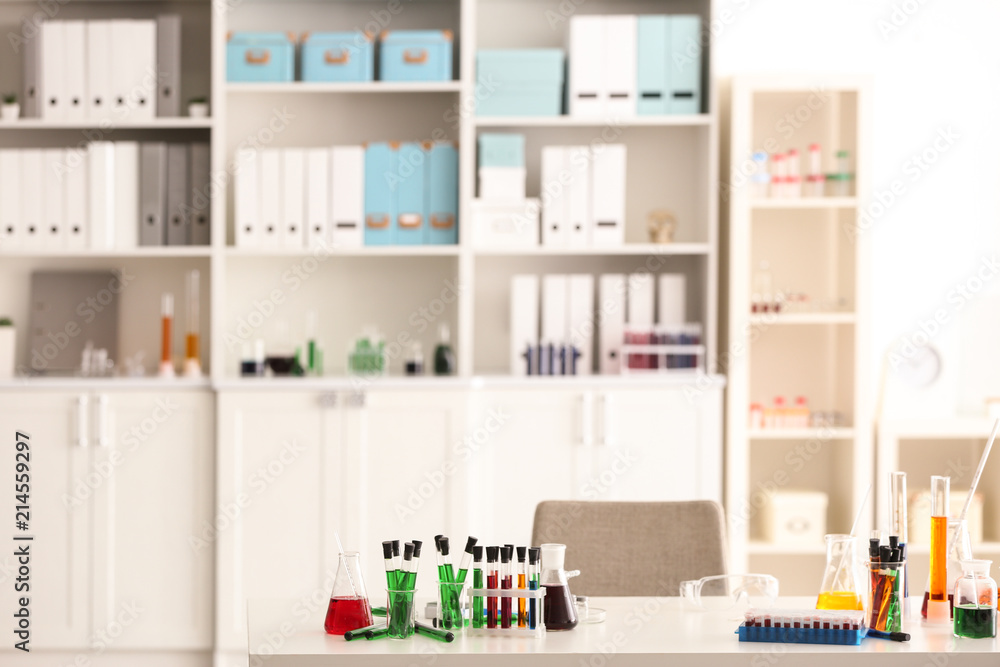 Fototapeta premium Interior of modern laboratory with chemical glassware on table
