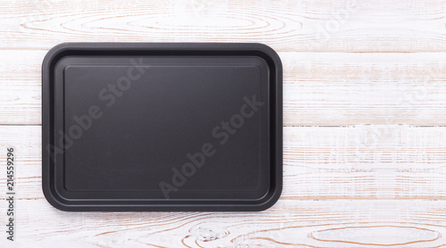 Empty baking tray for pizza close up on wooden background top view horizontally. Mock up for design