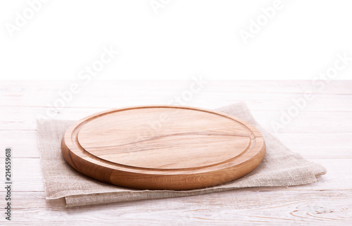 Napkin and board for pizza on wooden desk. Canvas, dish towels on white wooden table background top view mock up. Selective focus.