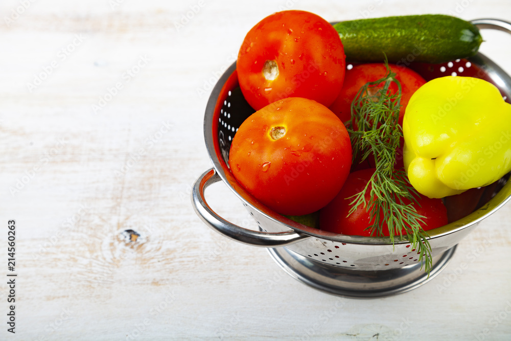 Tomatoes, peppers and cucumbers in a colander Tomatoes, peppers and cucumbers in a colander