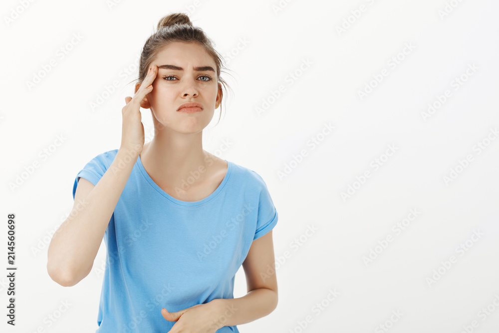 Girl feeling scared of getting old. Portrait of gloomy worried girlfriend frowning and touching wrinkles near eyes, beeing unhappy seing new facial or skin problems, posing over grey wall Girl feeling scared of getting old. Portrait of gloomy worried girlfriend frowning and touching wrinkles near eyes, beeing unhappy seing new facial or skin problems, posing over grey wall