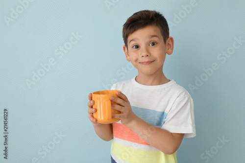 Cute little boy with cup of...