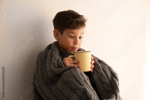 Cute little boy with cup of...