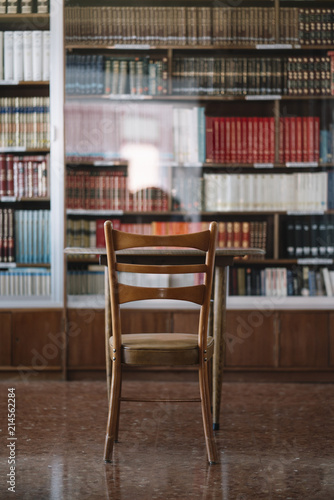 Back view of a table and chair in library.