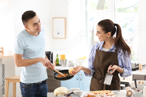 Young couple cooking togeth...