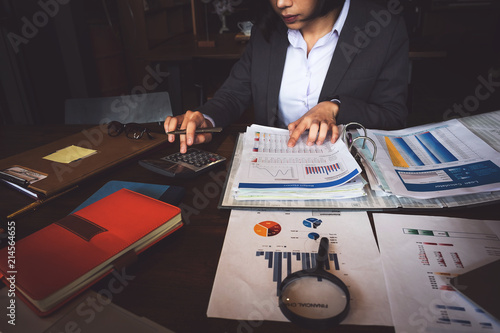 Business woman or Accountant working with calculator for investigation of corruption account. Anti Bribery concept.