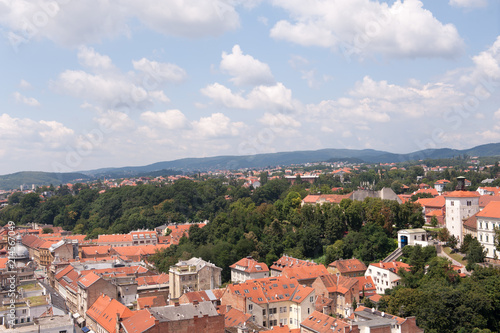View of Zagreb and tower Lotrscak and part of Upper town, Croatia. Old orange roofs. Old city in Europe. Panoramic view of Zagreb with blue sky and white clouds. © Domagoj