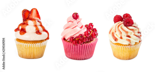 Set of cupcakes with raspberry, strawberry and redcurrant isolated on white