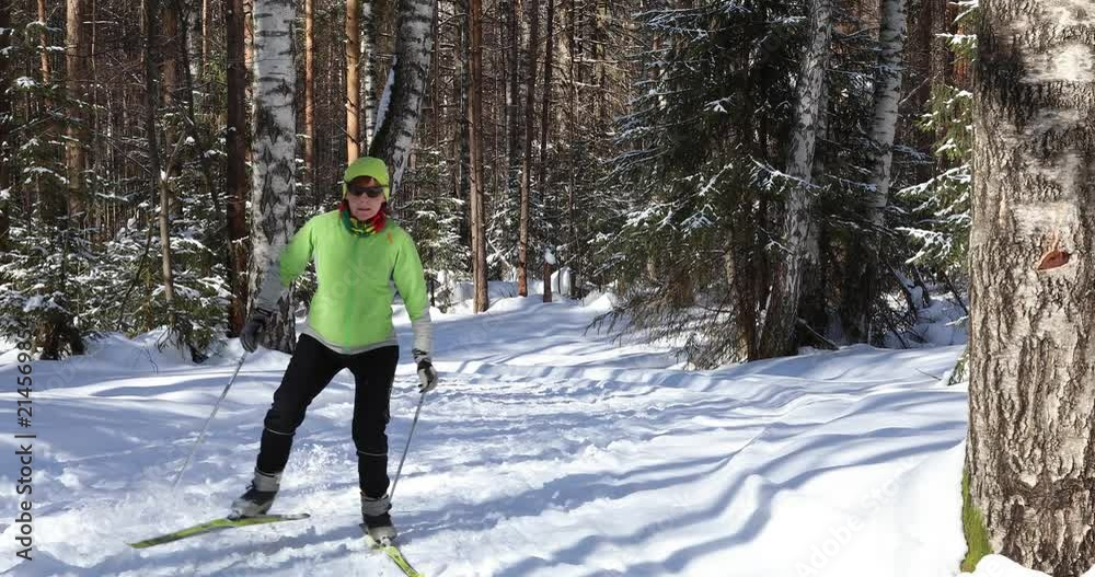 Young woman skiing in the winter forest. Bright sunny frosty day Young woman skiing in the winter forest. Bright sunny frosty day