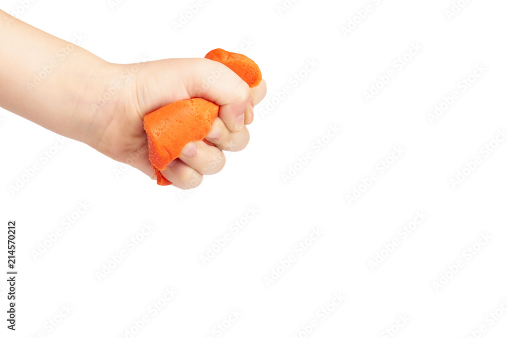 Orange plasticine bar with kid hand, isolated on white background. copy space template Orange plasticine bar with kid hand, isolated on white background. copy space template