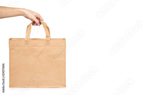 Reusable paper bag for groceries or gifts with hand, isolated on white background. copy space template
