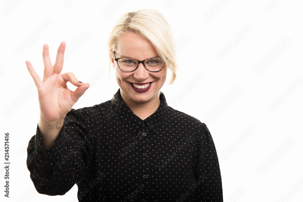 Young blonde female teacher wearing glasses showing ok gesture Young blonde female teacher wearing glasses showing ok gesture
