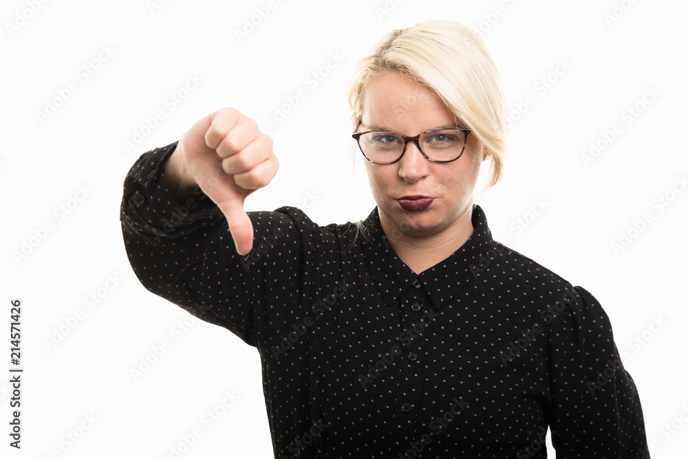 Young blonde female teacher wearing glasses showing thumb down gesture